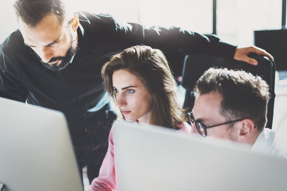 3 workers looking at computer screens