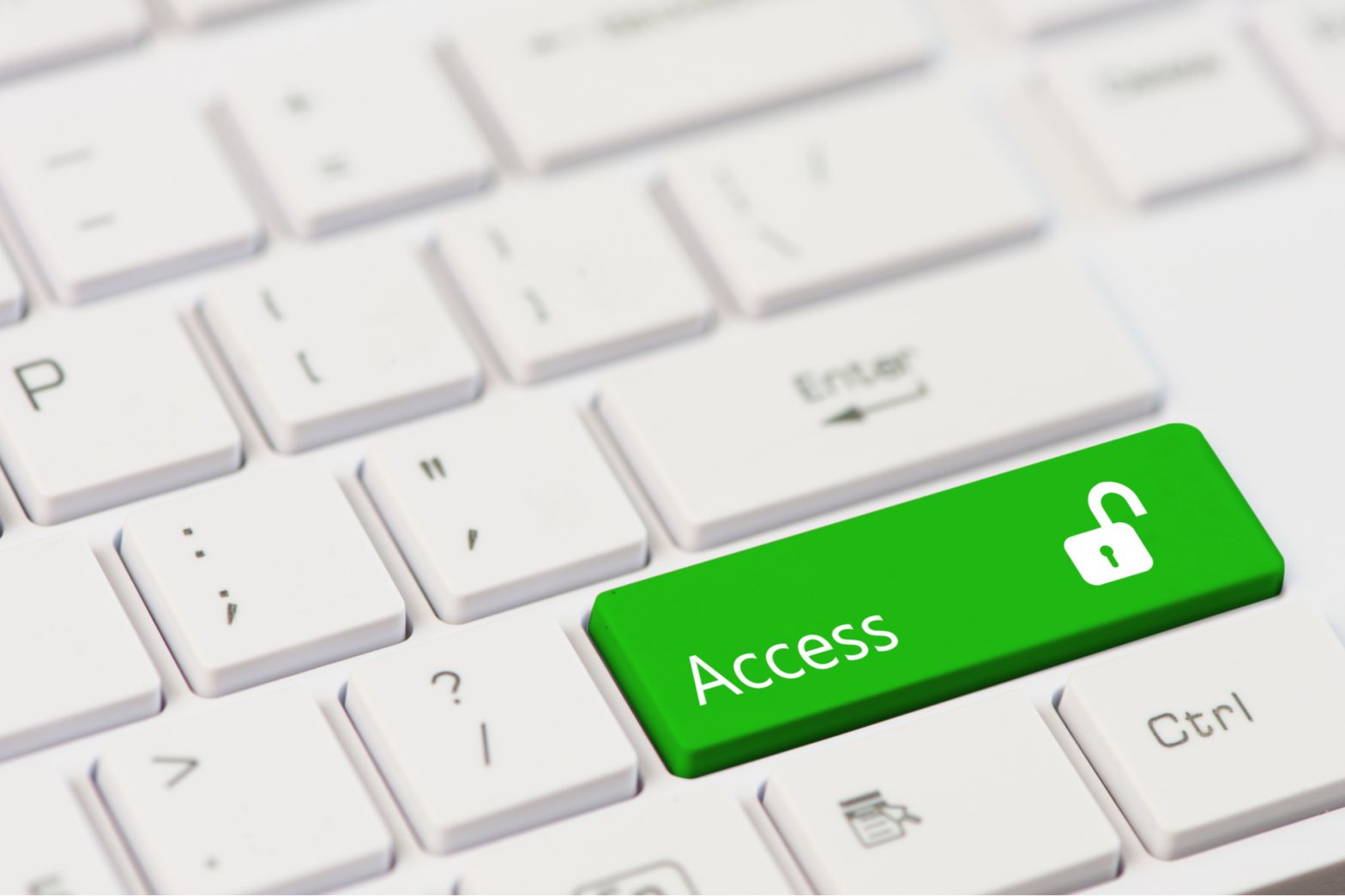 a close up of a computer keayboard. A green key with access and an unlocked icon is the main focus