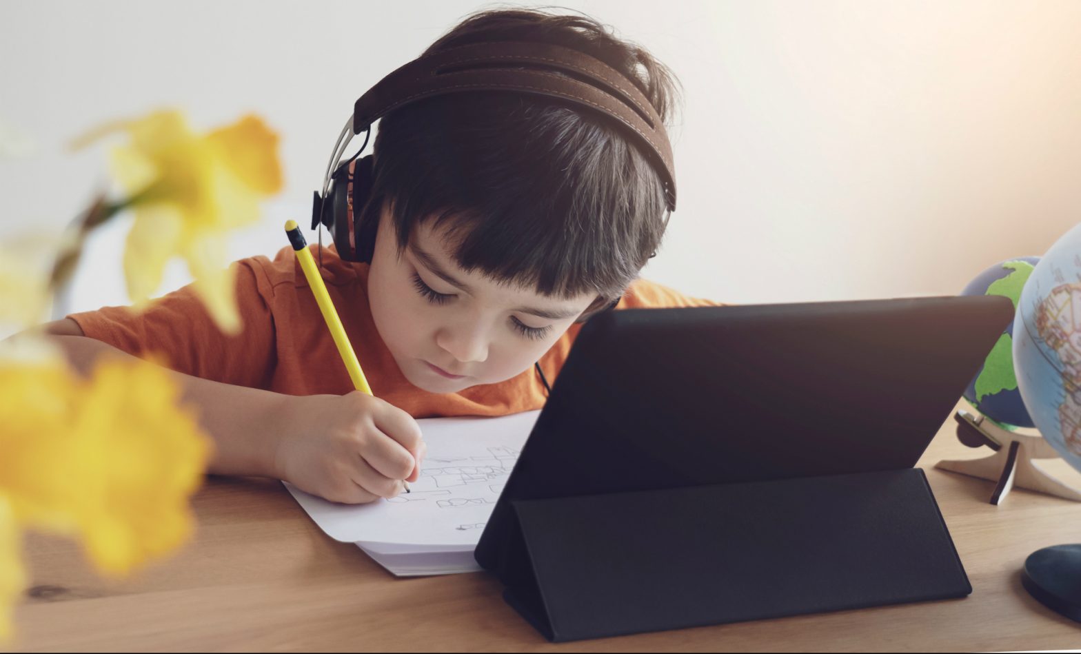 Boy learning using a tablet