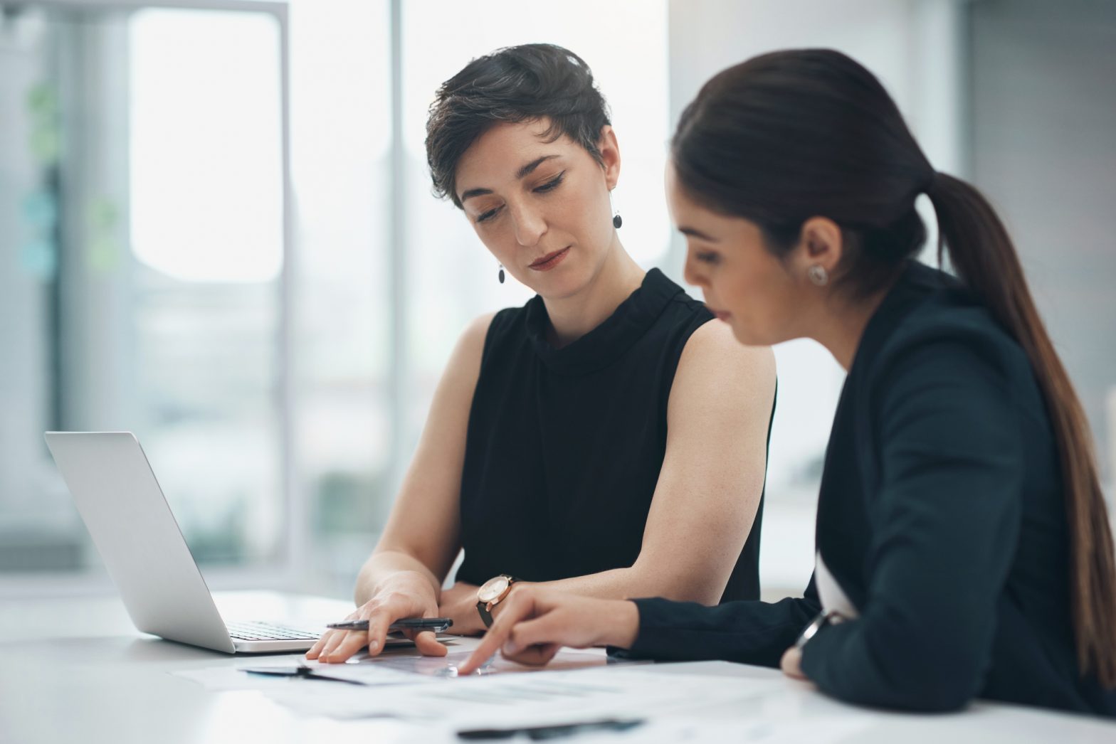 Businesswoman pointing at document in office for reading