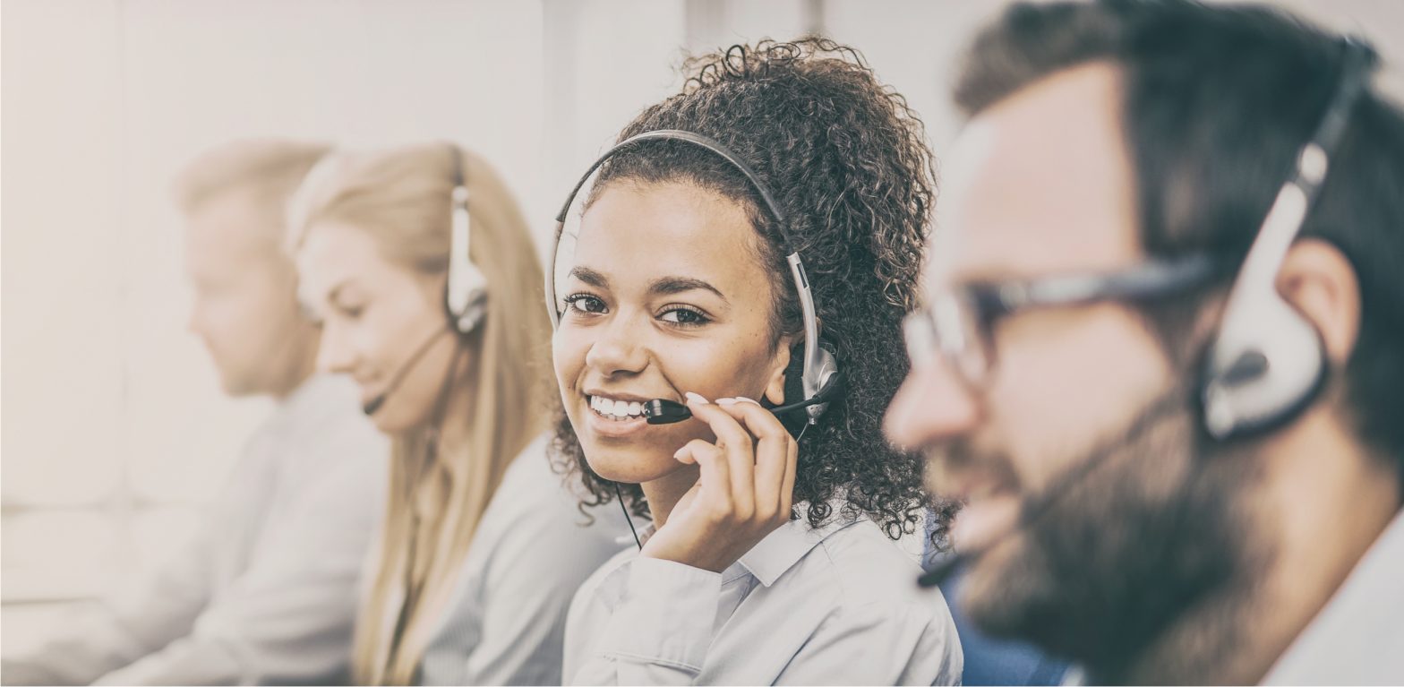 people in a row with telephone headsets on