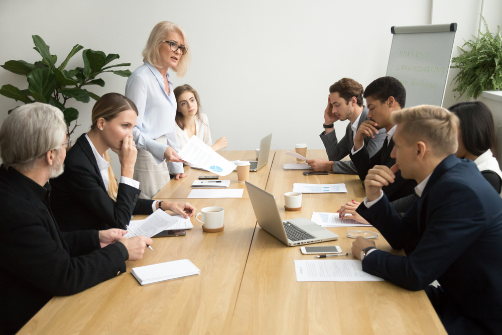 Diverse group of people round a table