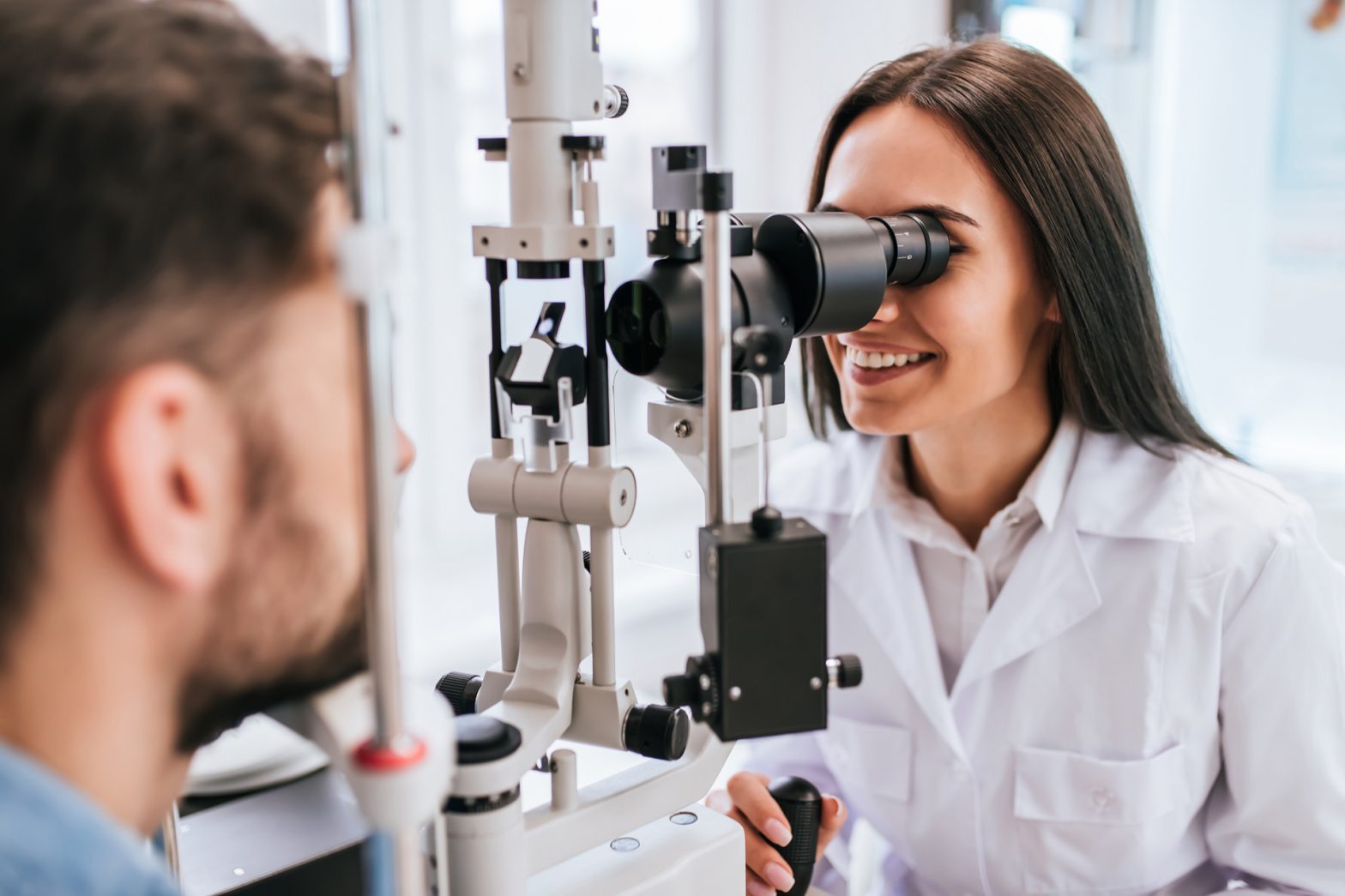 an opthamologist checks a patients eyes with a machine