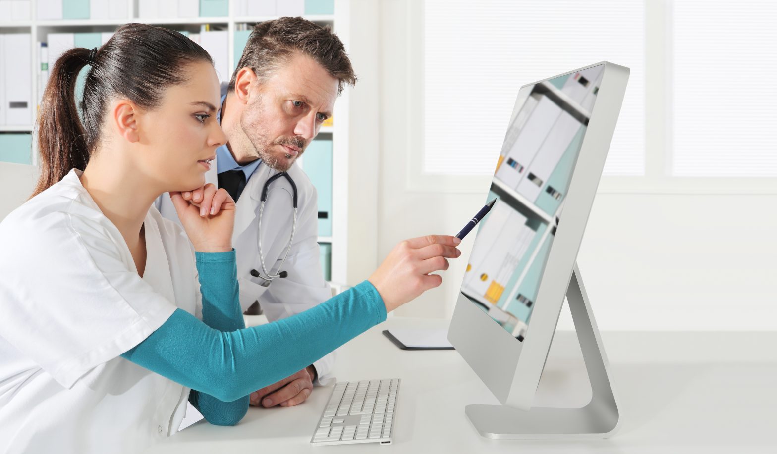 Two doctors looking at a computer screen