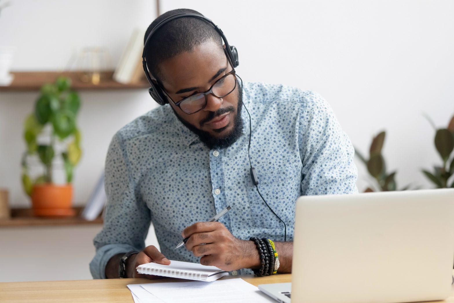 Man with headphones working at a laptop