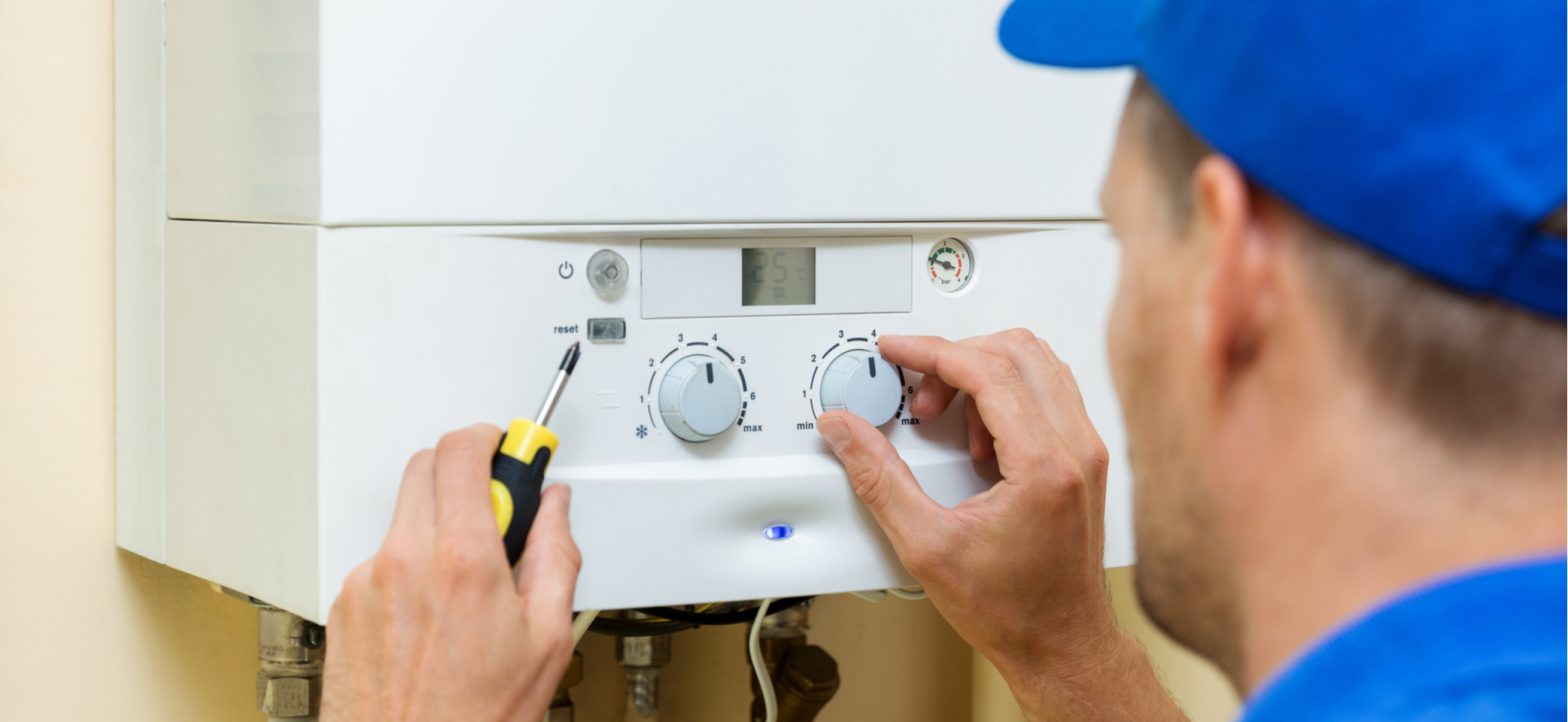 gas engineer fixing boiler