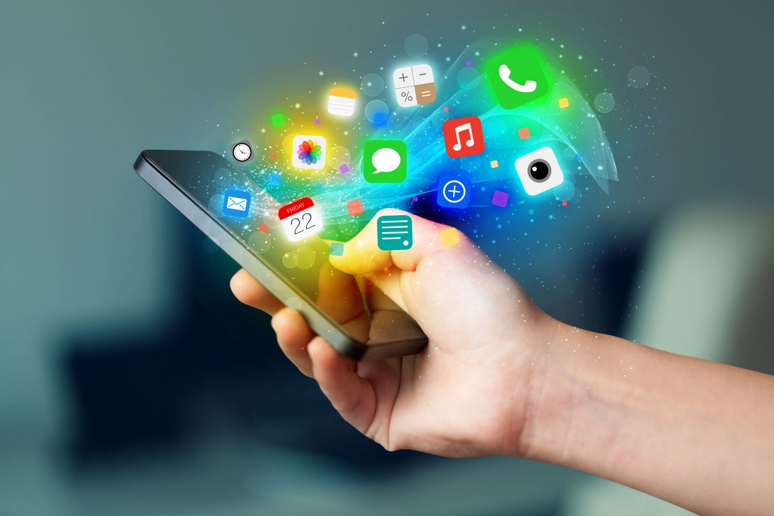 Hand holding smartphone with colorful app icons popping out