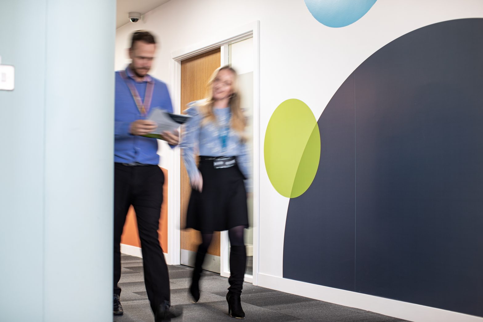 2 colleagues walking through CCS Liverpool office