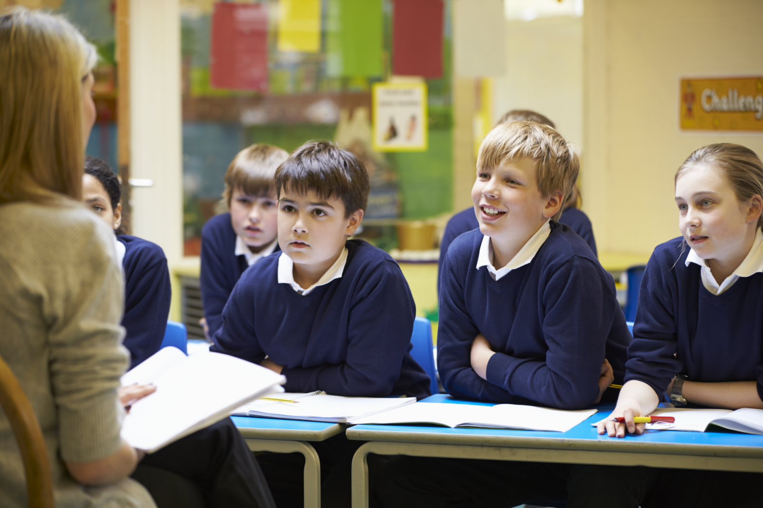 a school teacher reading to primary school children