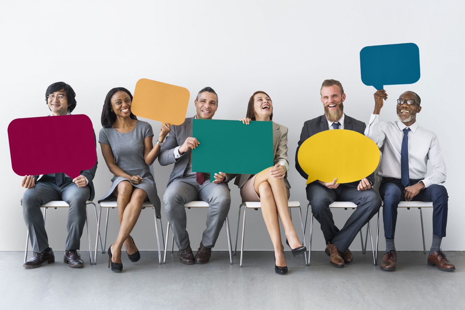 Group of workers holding various speech bubbles