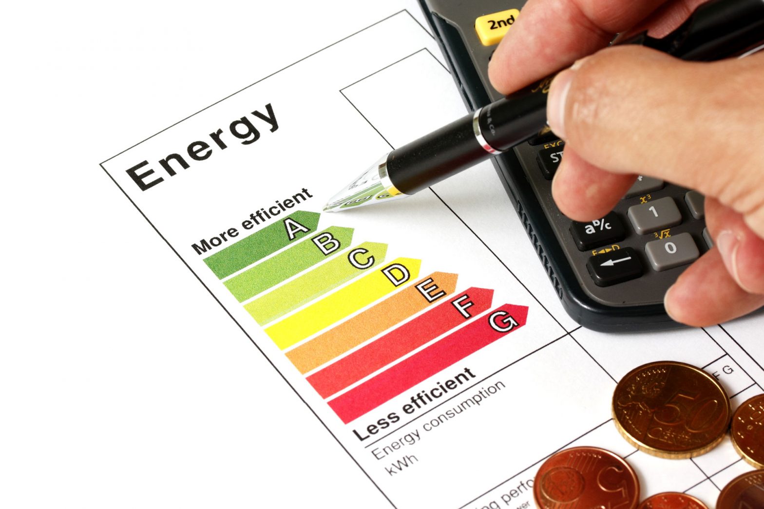 Man's hand with pen looking at an energy rating chart