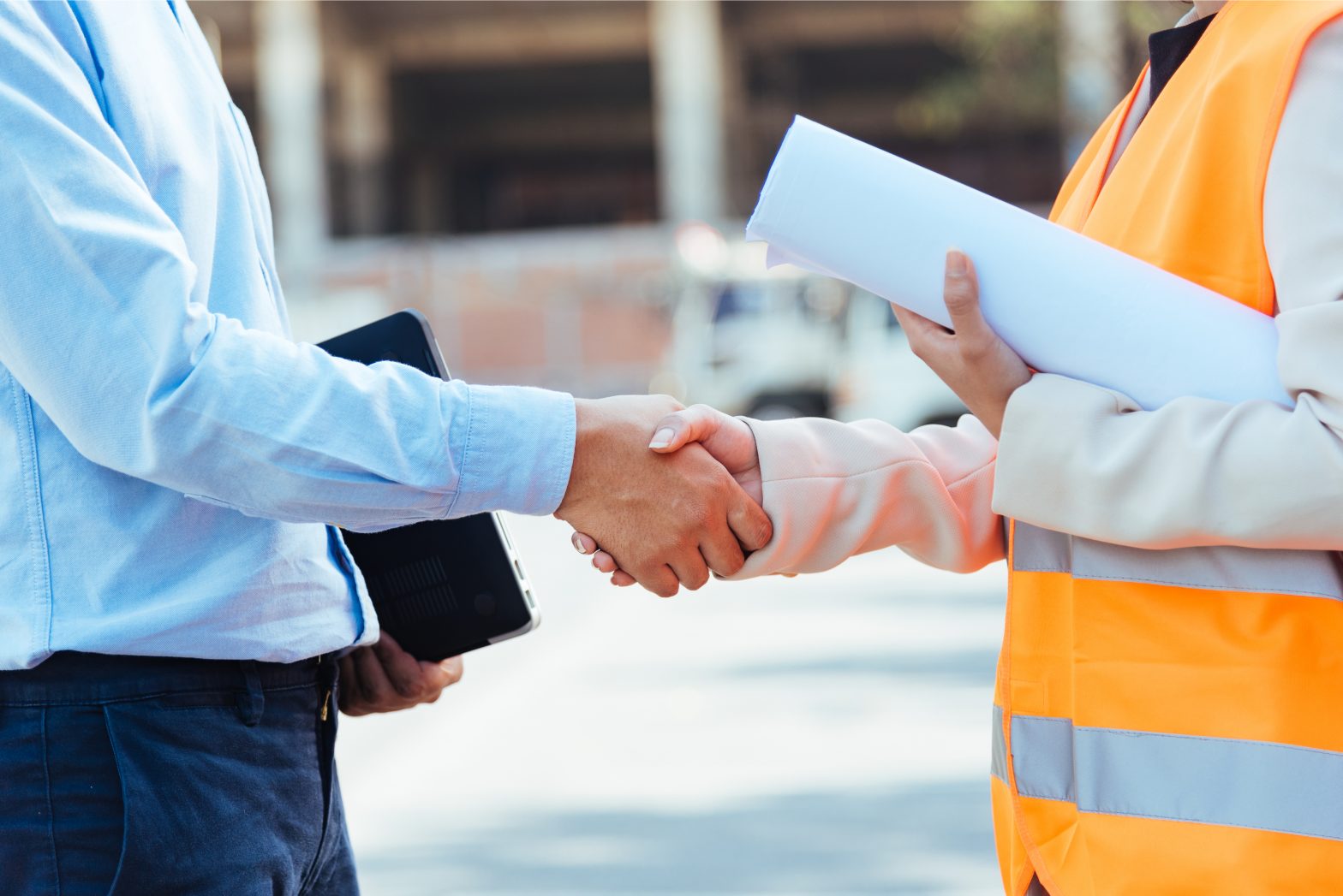 construction worker and business man handshake