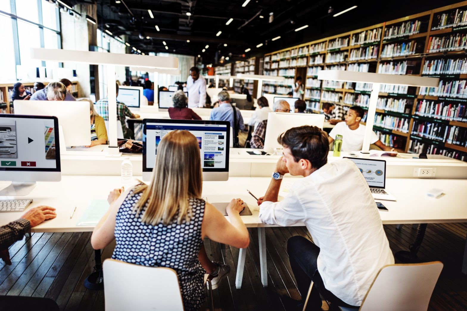 students in a library sat at computers