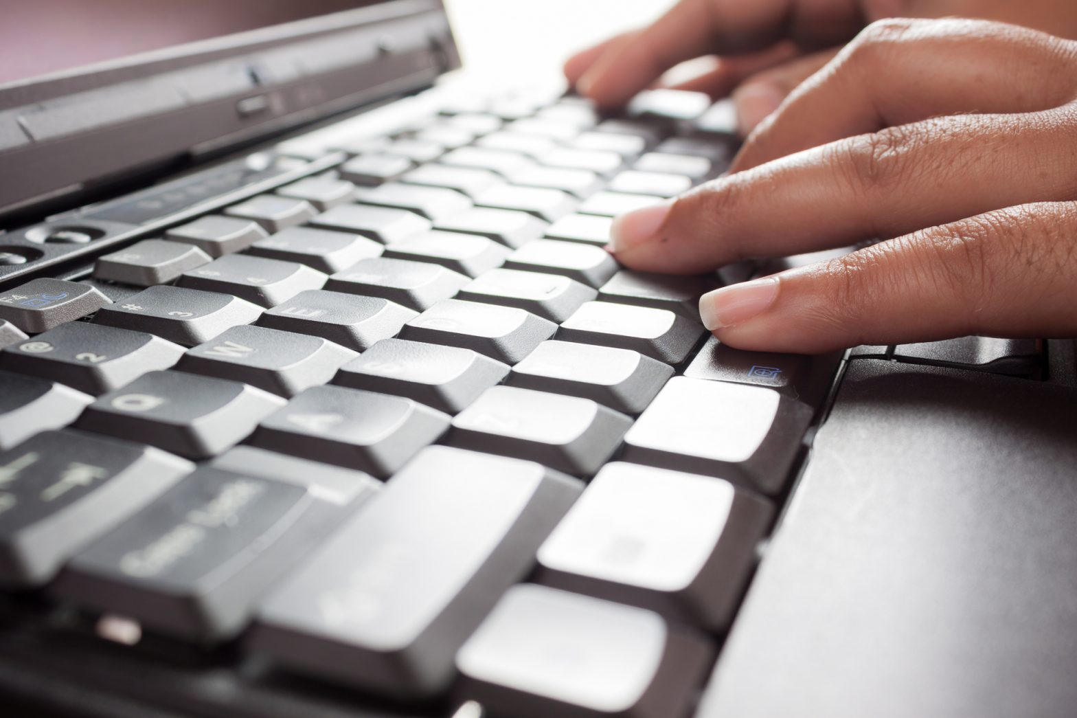 hands typing on a keyboard