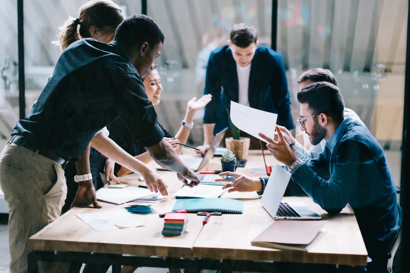 team of people working around a desk
