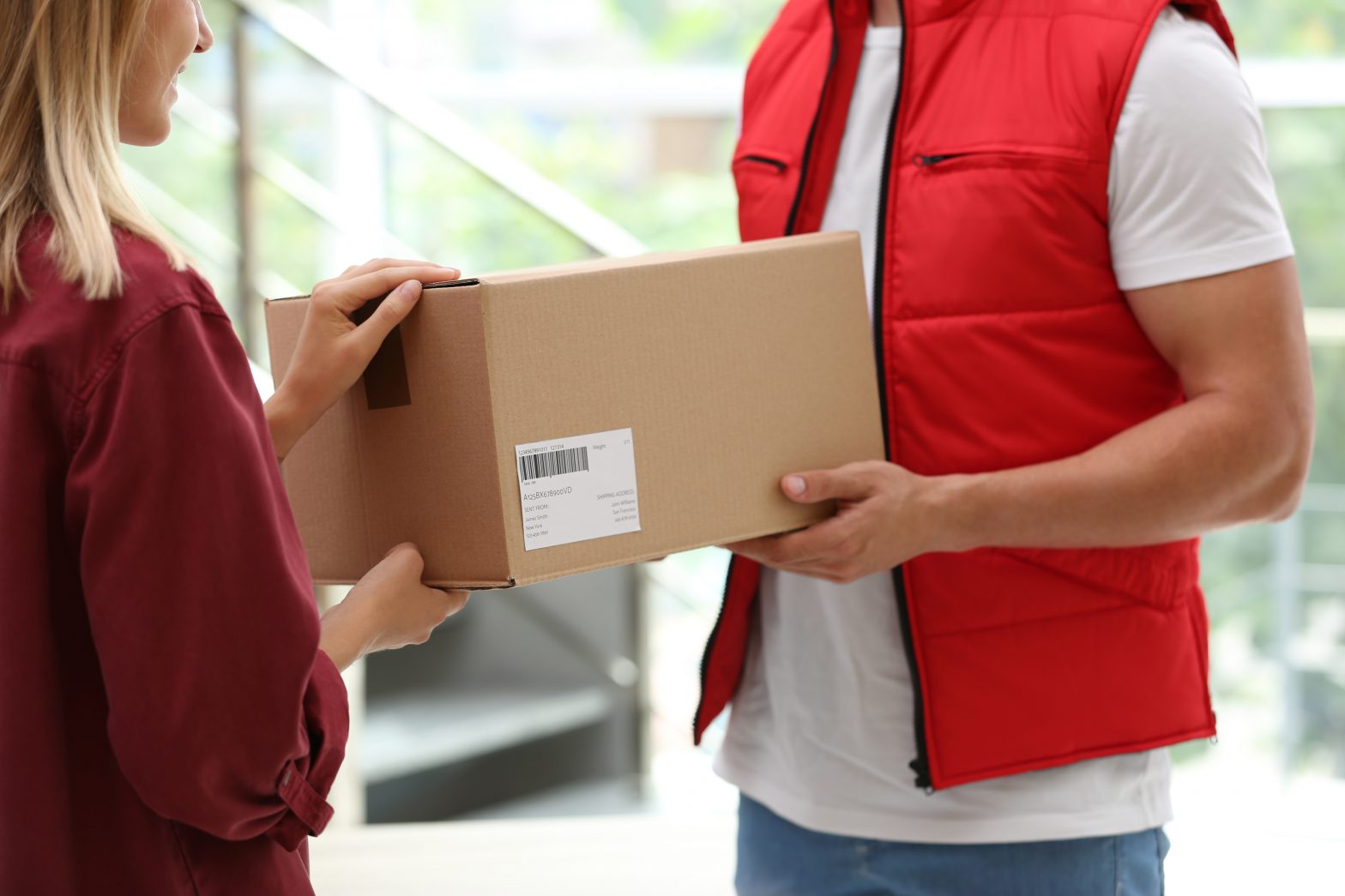Delivery man giving woman a parcel
