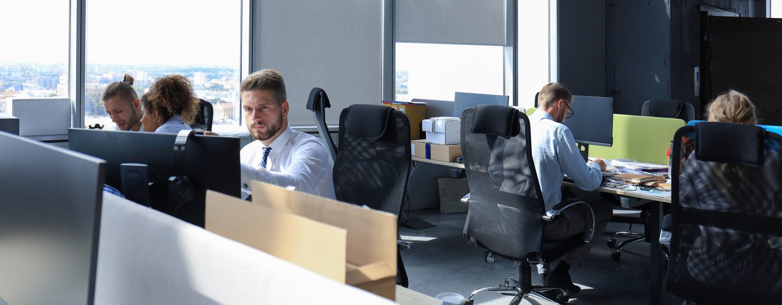 Multiple people working on computers in an office