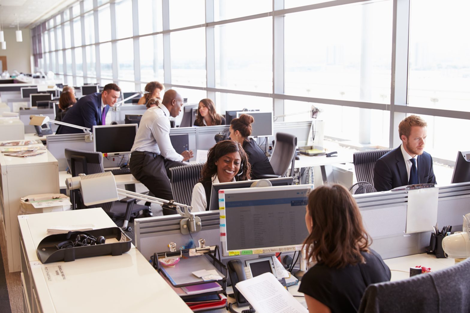 Group of people working on desktop computers in an office space