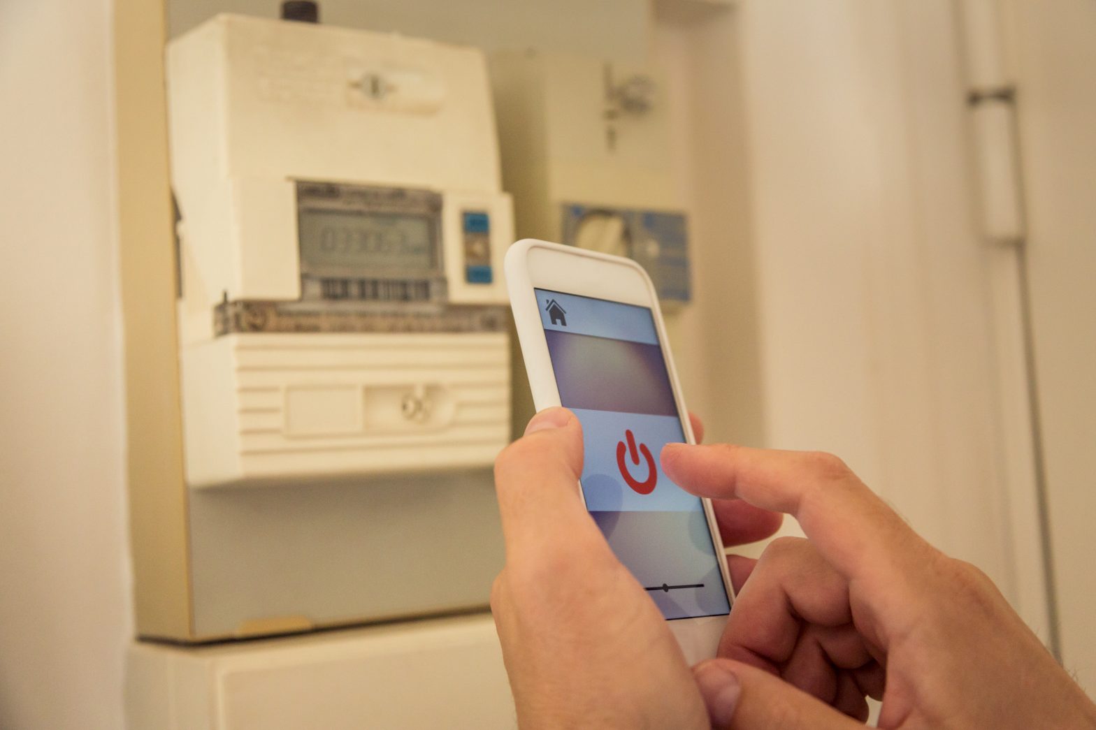 A customer using a mobile app, with a smart meter in the background