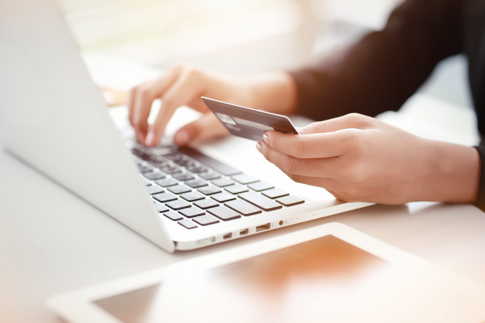 person doing an online payment with laptop