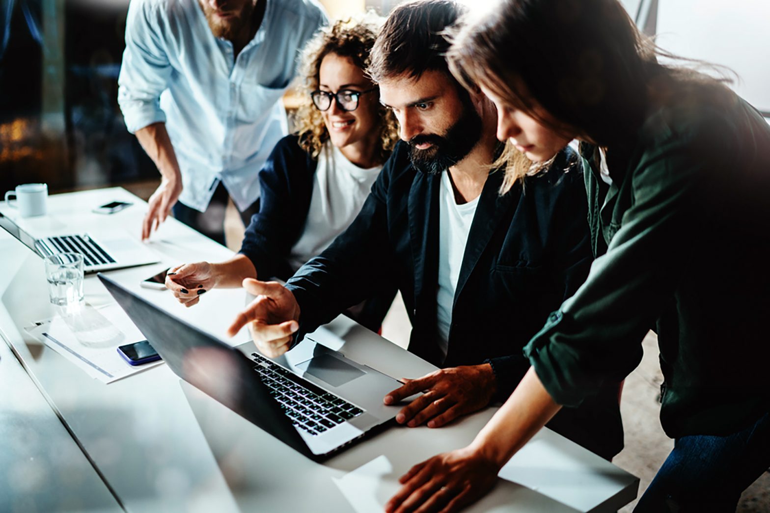 Work team looking at laptop screen