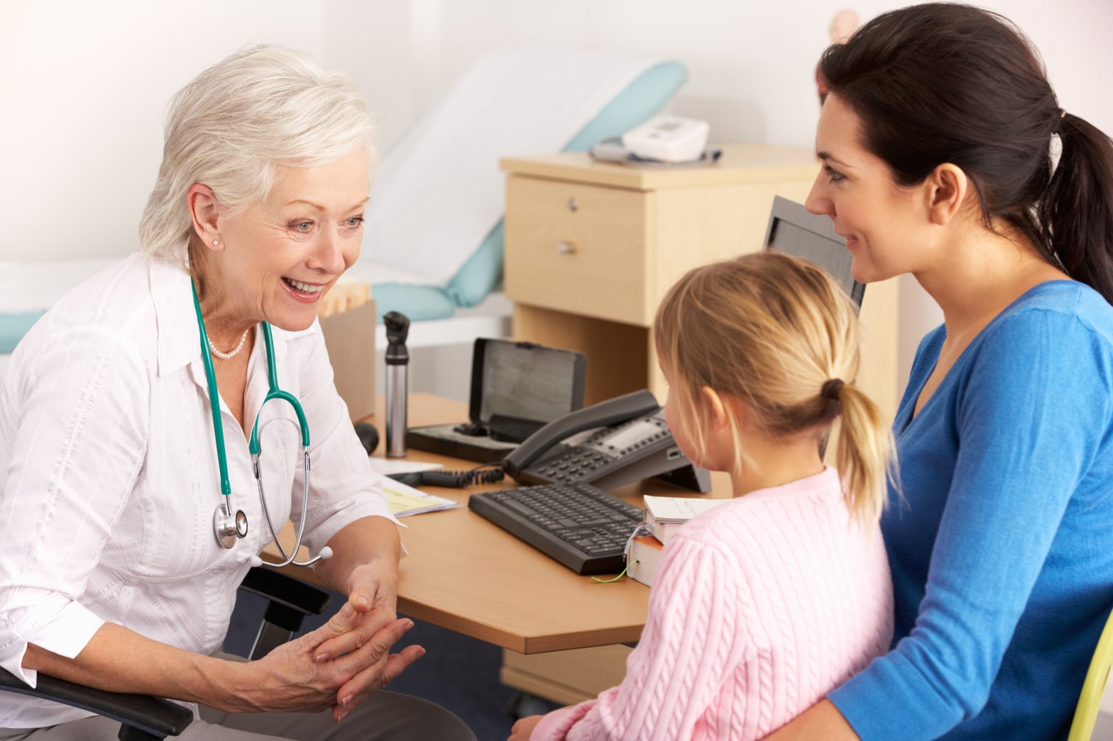 Image of a doctor speaking to a mother and child