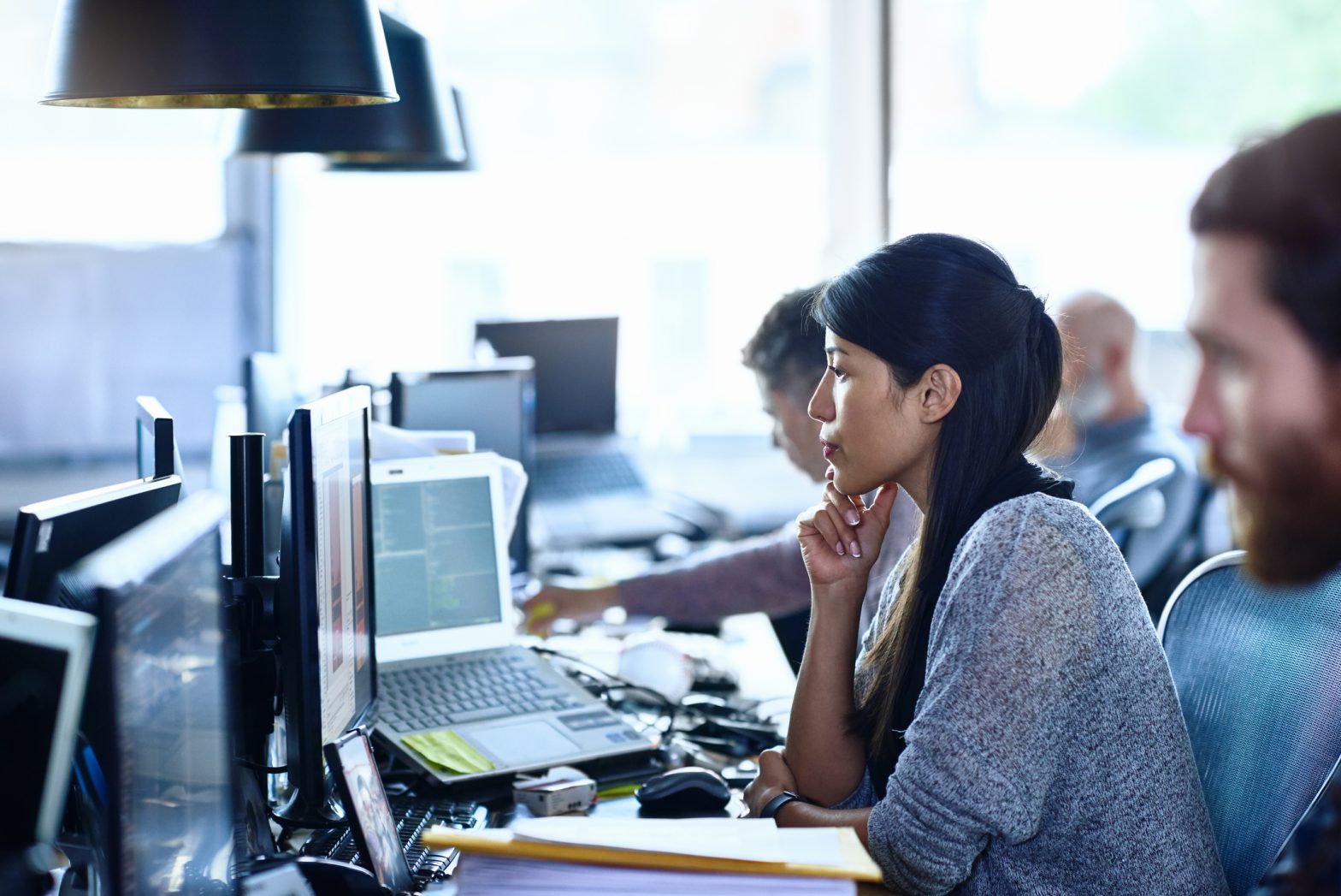 Team of creative people working at desks in modern office